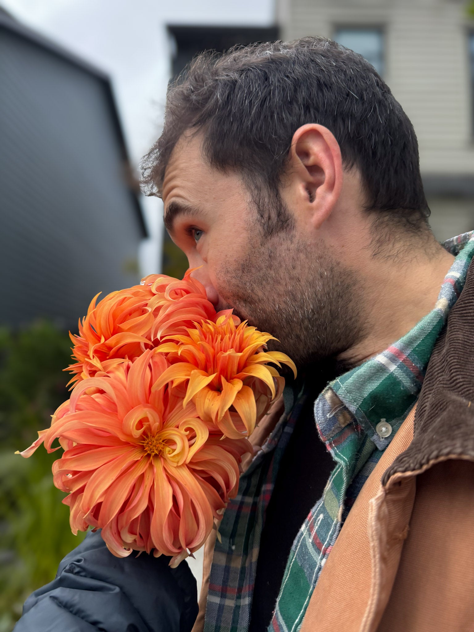 Taylor of Baby Bird Blooms Flower Farm smelling bouquet of freshly cut Bloomquist Jean flowers in autumn